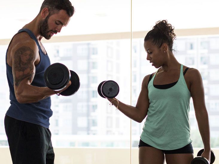 Man And Woman Lifting Weights In The Gym Man And Woman Lifting Weights In The Gym