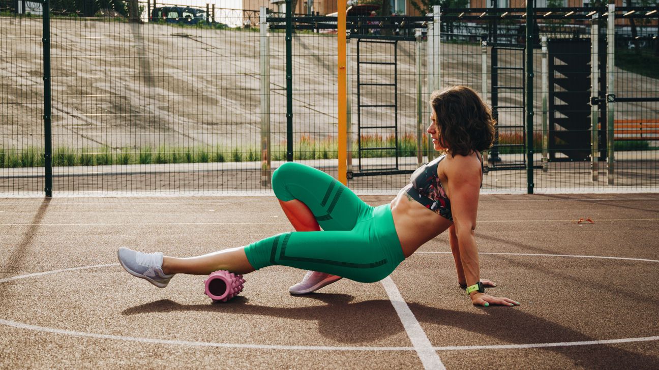 Woman foam rolling her calves