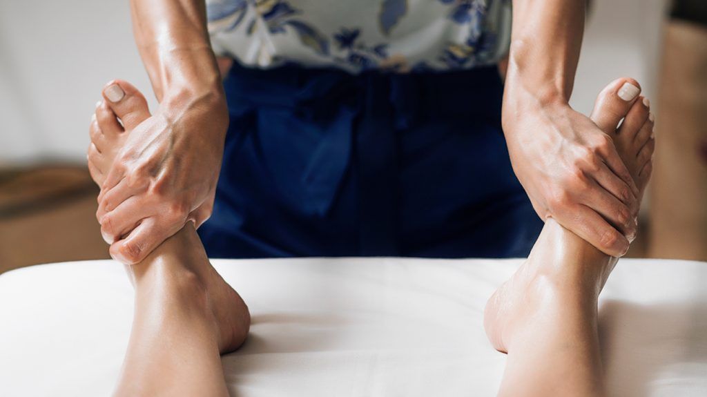 Person is getting a foot massage for self-care