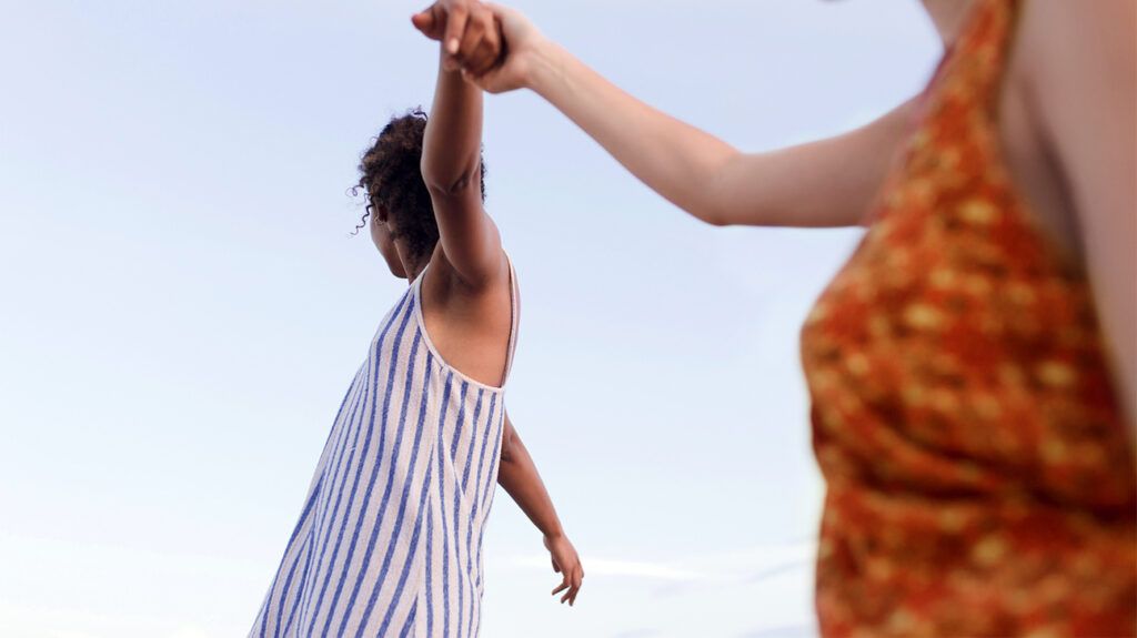 friends holding hands and dancing outside