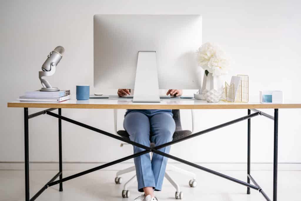 person sitting at desk and working on computer. How To Make Money Without A Job