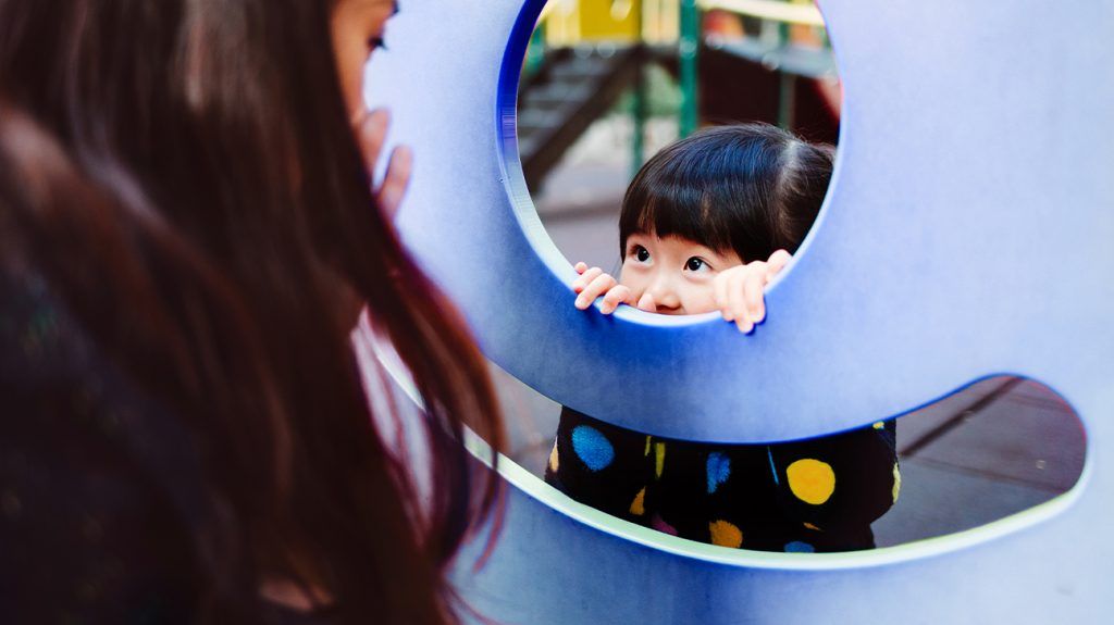 child playing on playground equipment