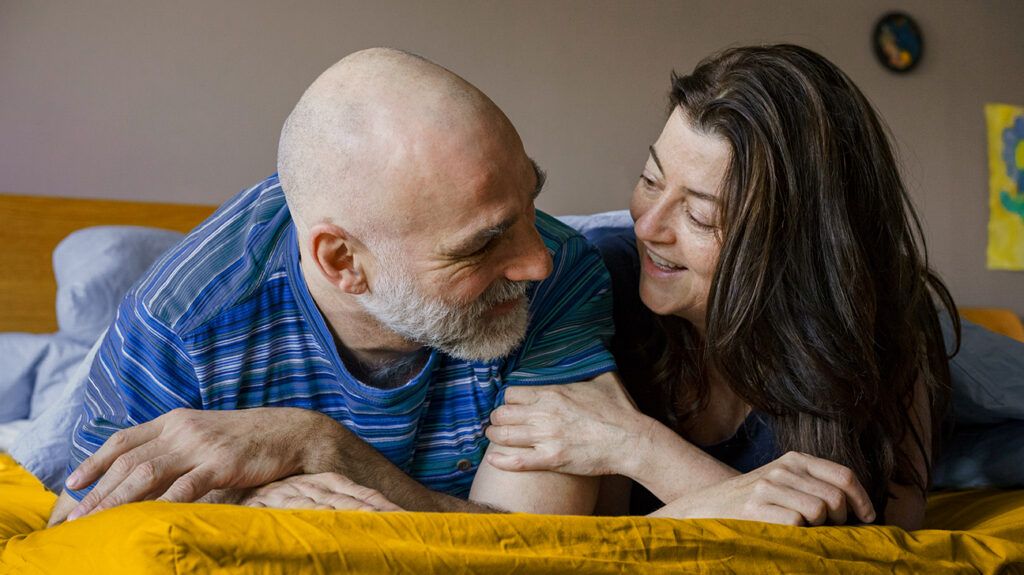 Couple lying in bed together