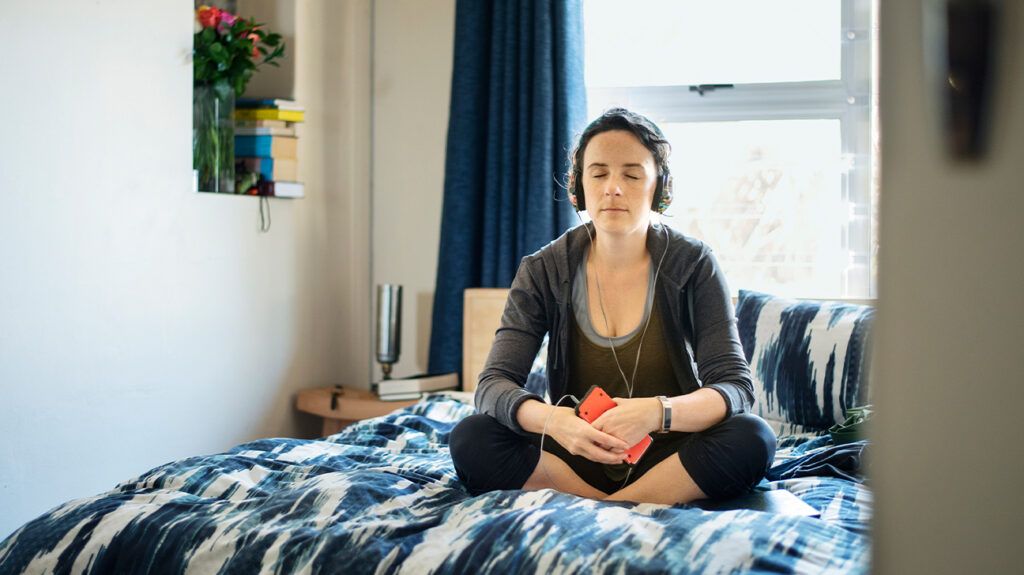 Person meditation on bed