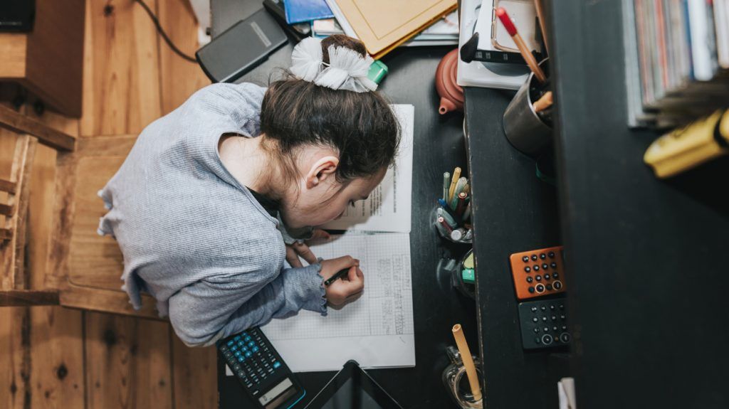 elementary student with specific learning disorder tries to focus on homework