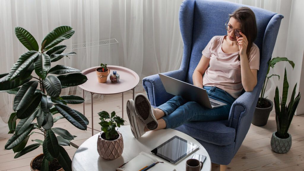 Woman sitting on a chair looking at her laptop