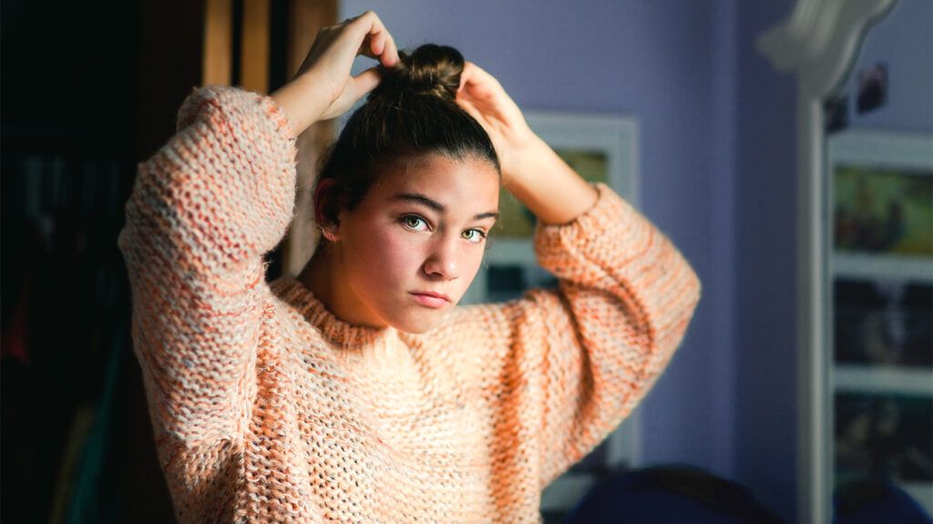 Young girl fixing hair