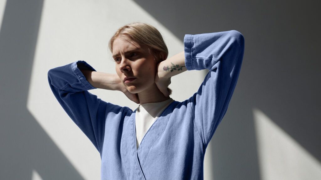 Young woman with hands in neck